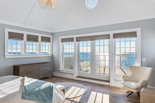 bedroom featuring vaulted ceiling with beams, access to exterior, a water view, hardwood / wood-style flooring, and wooden ceiling