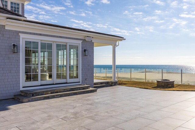 view of patio featuring a water view and a view of the beach