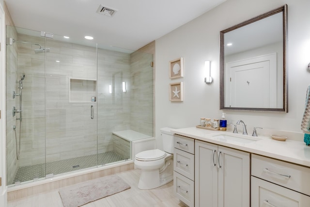 bathroom with toilet, an enclosed shower, and vanity