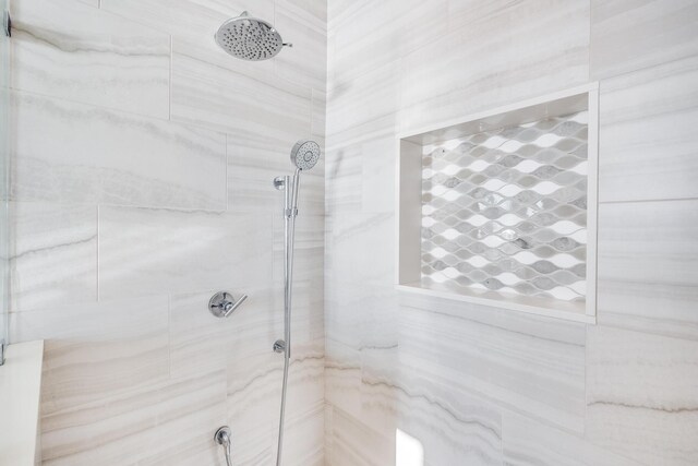 bathroom with a tile shower