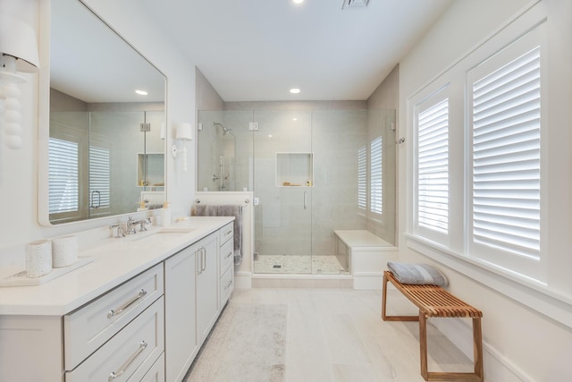 bathroom with vanity and a shower with shower door