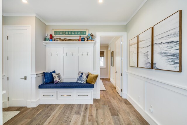 mudroom with light hardwood / wood-style floors and ornamental molding