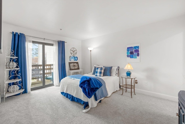 bedroom with carpet flooring, baseboards, and access to exterior