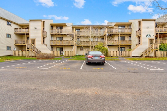 view of building exterior featuring uncovered parking
