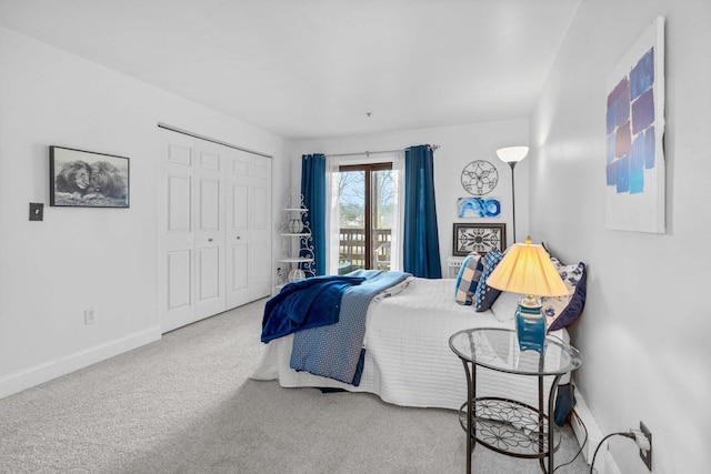 carpeted bedroom with baseboards, a closet, and access to outside