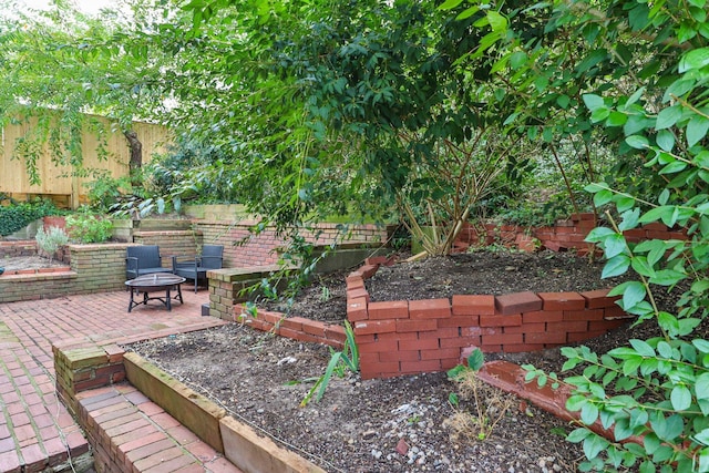 view of yard with an outdoor fire pit and a patio