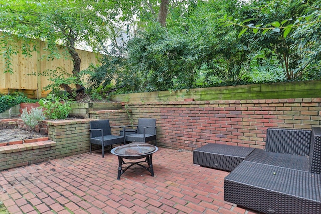 view of patio / terrace with an outdoor living space with a fire pit