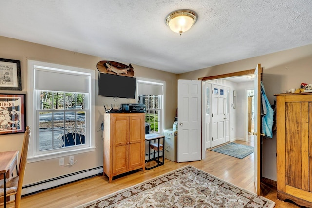 95 Red Brook Rd, Waquoit, MA 02536 - entrance foyer featuring light wood-style floors, a baseboard heating unit, and a textured ceiling