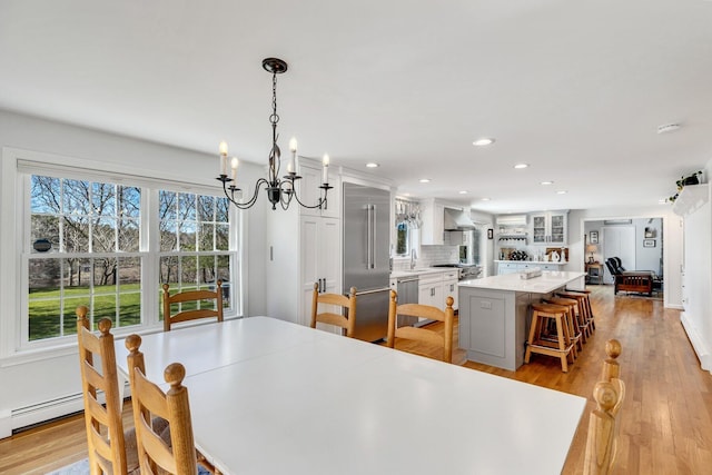 95 Red Brook Rd, Waquoit, MA 02536 - dining space with a baseboard heating unit, recessed lighting, a notable chandelier, and light wood-type flooring