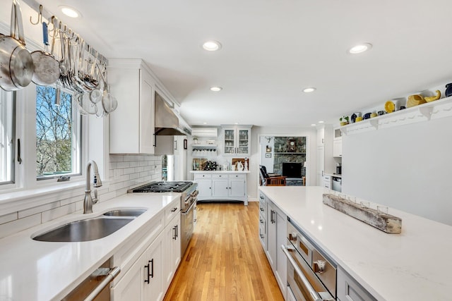 95 Red Brook Rd, Waquoit, MA 02536 - kitchen with tasteful backsplash, white cabinets, recessed lighting, under cabinet range hood, and a sink