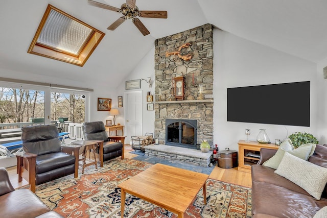 95 Red Brook Rd, Waquoit, MA 02536 - living room featuring ceiling fan, high vaulted ceiling, a stone fireplace, a skylight, and wood finished floors