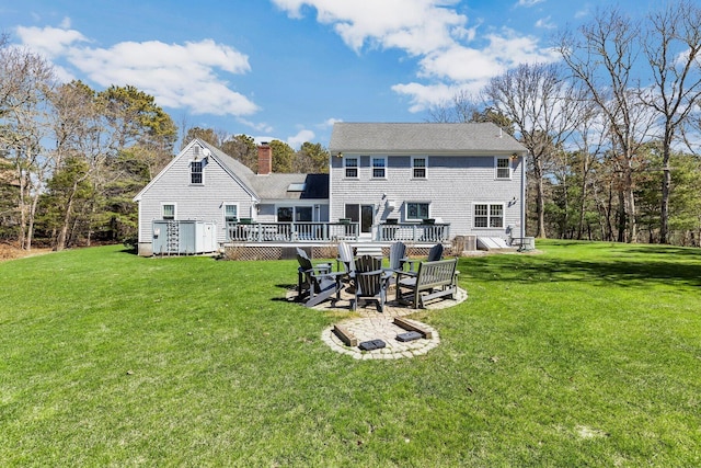 95 Red Brook Rd, Waquoit, MA 02536 - rear view of property with an outdoor fire pit, a chimney, a deck, and a yard