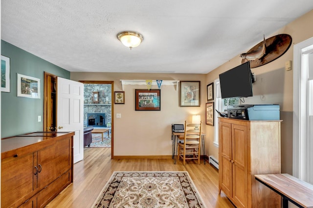 95 Red Brook Rd, Waquoit, MA 02536 - interior space with light wood finished floors, baseboard heating, baseboards, and a textured ceiling