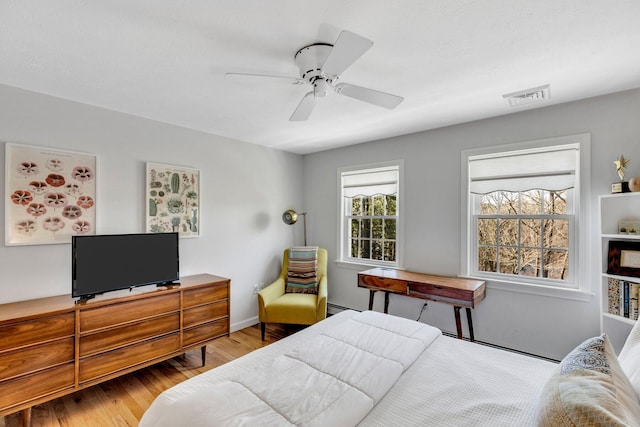95 Red Brook Rd, Waquoit, MA 02536 - bedroom featuring a ceiling fan, visible vents, baseboard heating, wood finished floors, and baseboards