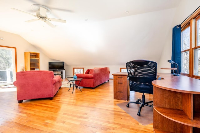 office with light wood finished floors, vaulted ceiling, and a ceiling fan