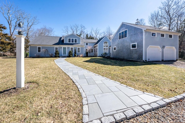 view of front of home featuring a front yard and an attached garage