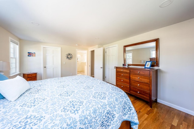 bedroom with baseboards and wood finished floors