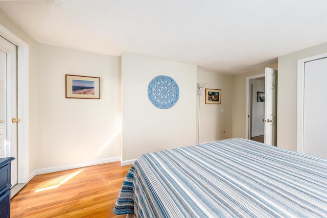 bedroom featuring baseboards and light wood-style floors