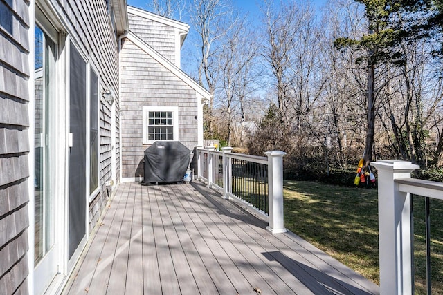 wooden deck with a yard and area for grilling