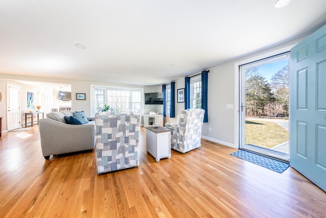 living room with light wood-type flooring and baseboards