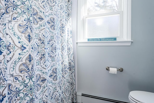 full bath featuring a baseboard heating unit, curtained shower, and toilet