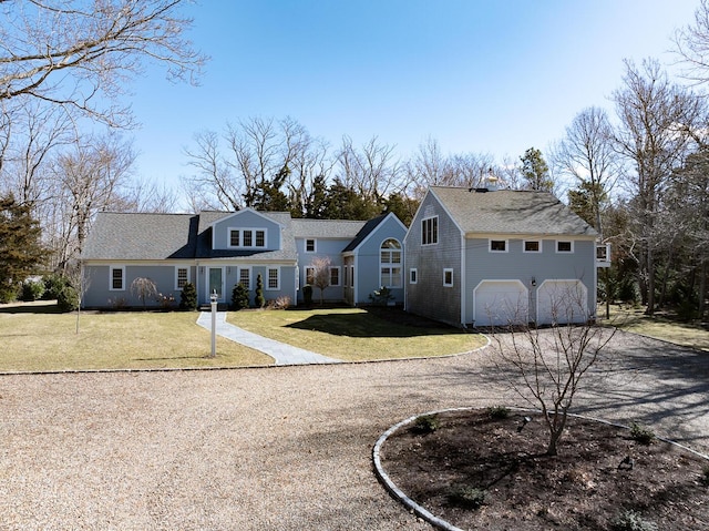 view of front facade featuring a garage, a front yard, and driveway