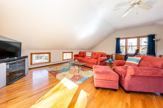 living area with lofted ceiling, wood-type flooring, and baseboard heating