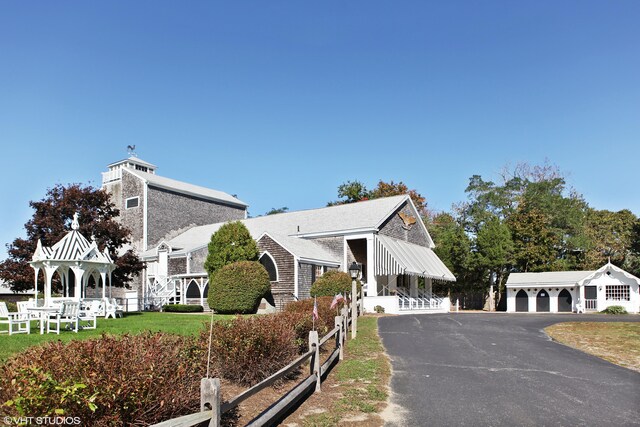 view of front of home featuring a garage and an outbuilding