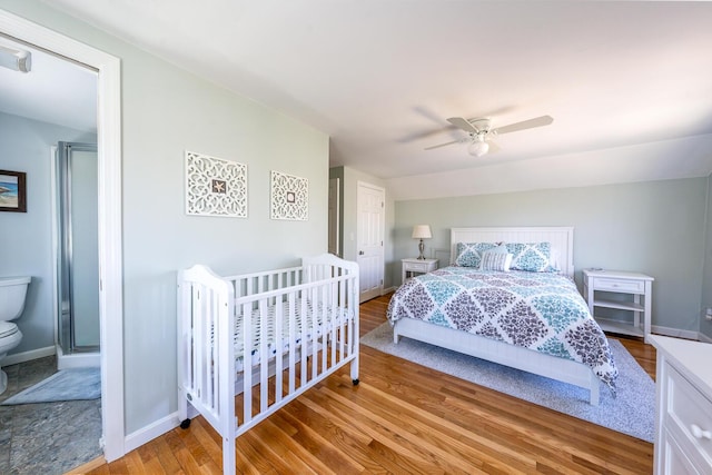 bedroom with wood finished floors, a ceiling fan, and baseboards