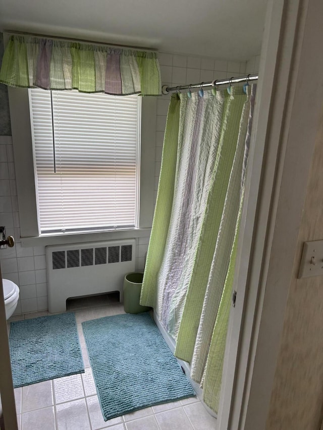 2 Shell Ln, Orleans, MA 02653 - bathroom with radiator heating unit, tile walls, tile patterned flooring, and curtained shower