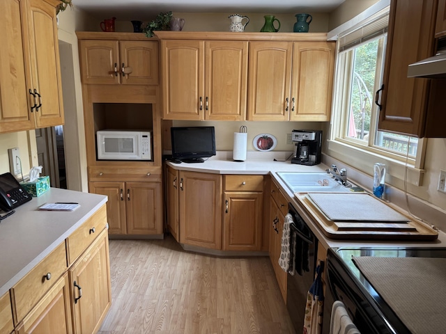 2 Shell Ln, Orleans, MA 02653 - kitchen with white microwave, light wood-style flooring, light countertops, and range