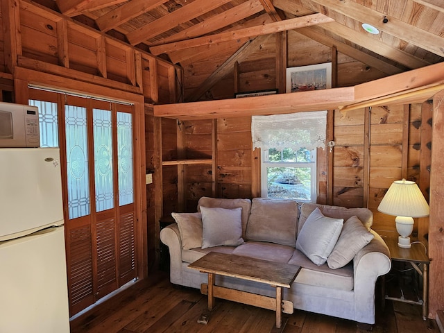living area featuring vaulted ceiling and hardwood / wood-style flooring