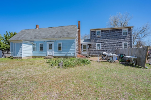 69 Upper County Rd, South Dennis, MA 02660 - rear view of house featuring a chimney