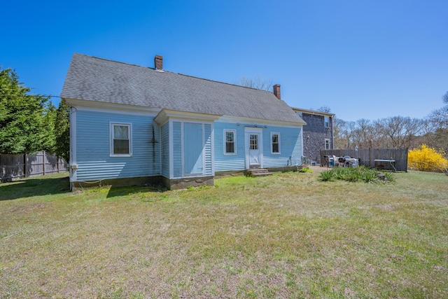 69 Upper County Rd, South Dennis, MA 02660 - rear view of house with a chimney and entry steps
