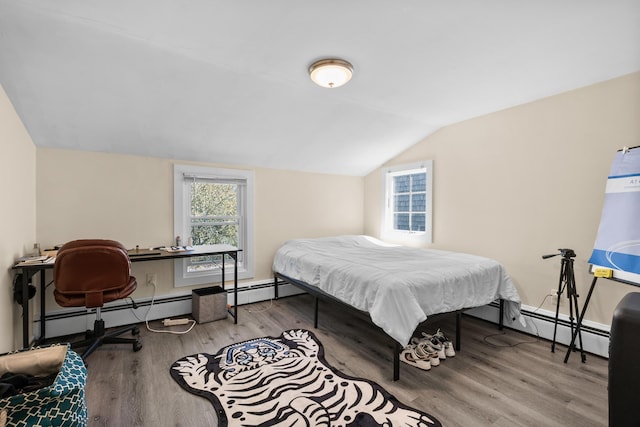 69 Upper County Rd, South Dennis, MA 02660 - bedroom with lofted ceiling, wood finished floors, baseboard heating, and a desk