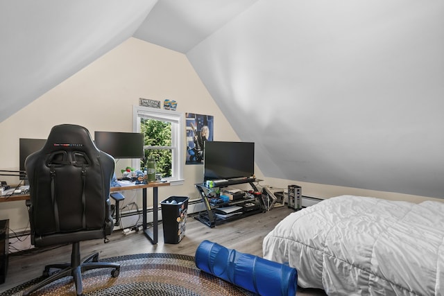 69 Upper County Rd, South Dennis, MA 02660 - bedroom featuring wood finished floors, vaulted ceiling, an office area, a baseboard radiator, and baseboard heating