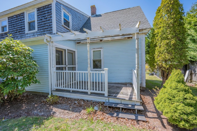 69 Upper County Rd, South Dennis, MA 02660 - rear view of house with a wooden deck, a chimney, a pergola, and roof with shingles