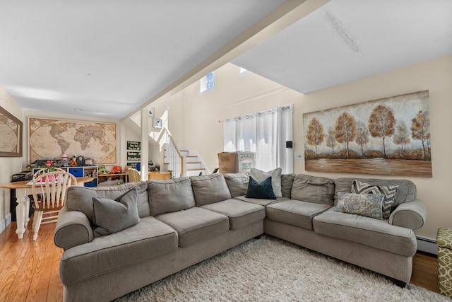 69 Upper County Rd, South Dennis, MA 02660 - living area featuring a baseboard heating unit, wood finished floors, and stairs