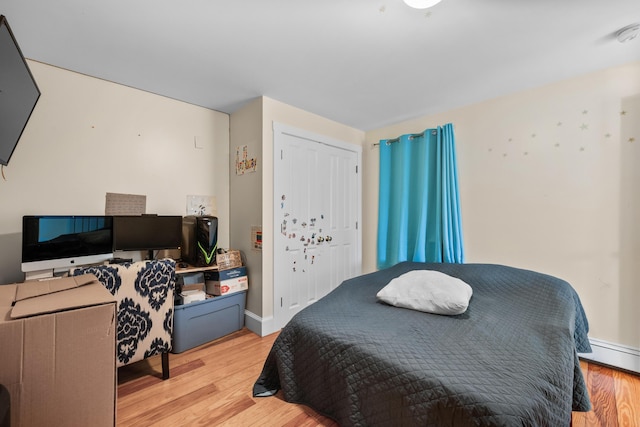 69 Upper County Rd, South Dennis, MA 02660 - bedroom with light wood-style flooring, a baseboard radiator, and a closet