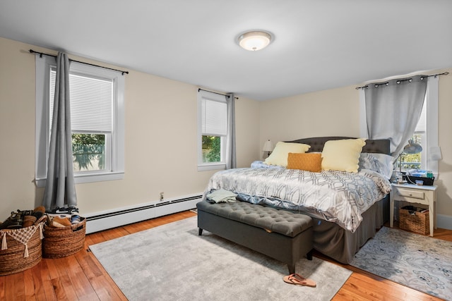 69 Upper County Rd, South Dennis, MA 02660 - bedroom featuring a baseboard radiator, multiple windows, and wood finished floors
