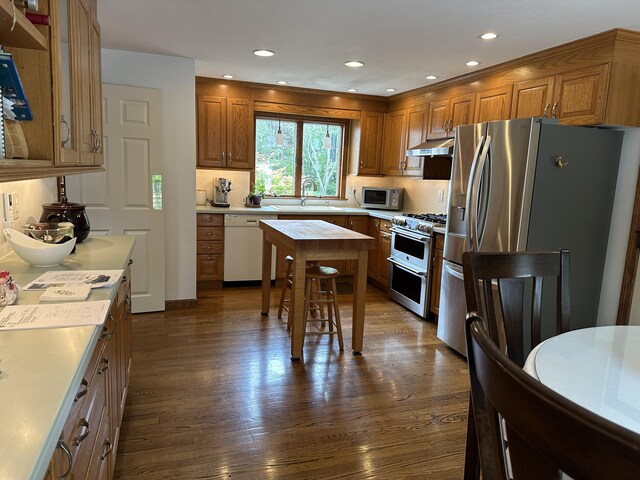 11 Polaris Dr, Mashpee, MA 02649 - kitchen featuring stainless steel appliances, under cabinet range hood, a sink, light countertops, and brown cabinets