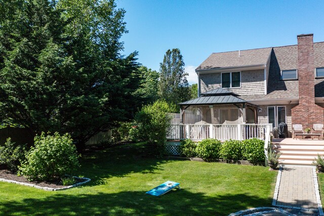 11 Polaris Dr, Mashpee, MA 02649 - view of front of home with a gazebo, a front yard, a deck, roof with shingles, and a chimney