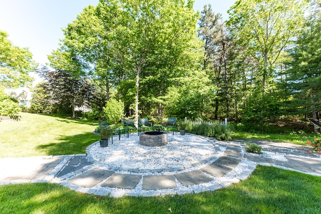 11 Polaris Dr, Mashpee, MA 02649 - view of grassy yard featuring an outdoor fire pit and a patio area