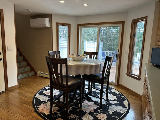 11 Polaris Dr, Mashpee, MA 02649 - dining space with a wall mounted AC, a baseboard radiator, wood finished floors, recessed lighting, and stairway