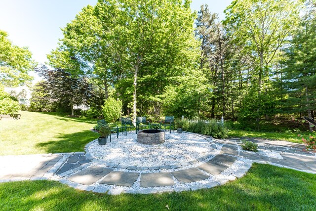 11 Polaris Dr, Mashpee, MA 02649 - view of grassy yard featuring an outdoor fire pit and a patio area