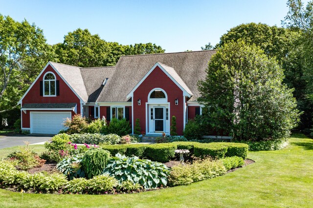 11 Polaris Dr, Mashpee, MA 02649 - view of front facade with asphalt driveway, a front lawn, and an attached garage