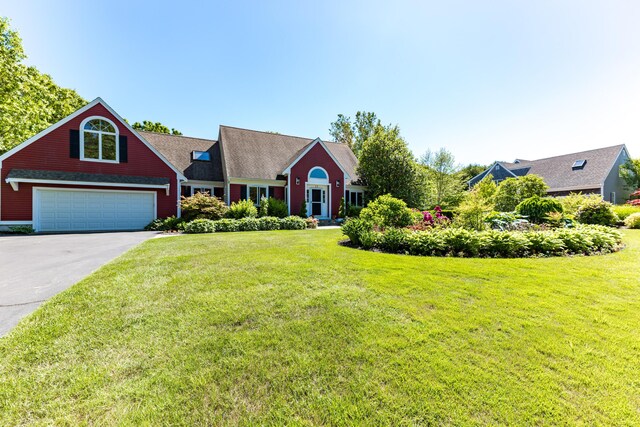 11 Polaris Dr, Mashpee, MA 02649 - view of front facade featuring concrete driveway, a front yard, and a garage