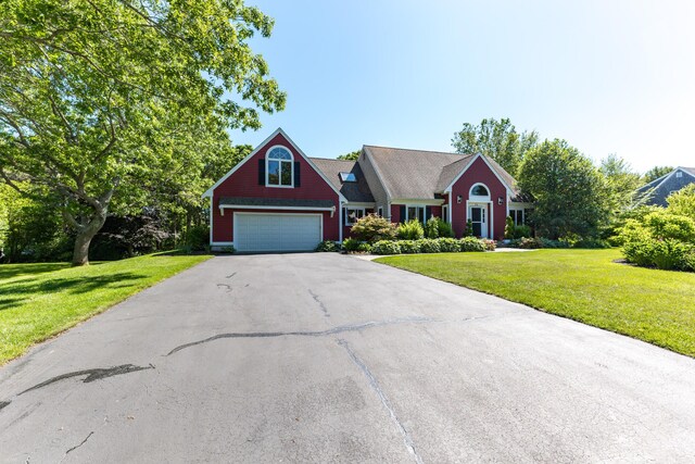 11 Polaris Dr, Mashpee, MA 02649 - view of front of house with asphalt driveway, a front lawn, and an attached garage