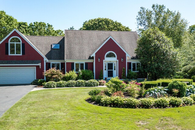 11 Polaris Dr, Mashpee, MA 02649 - view of front of home featuring a front yard, concrete driveway, a garage, and roof with shingles