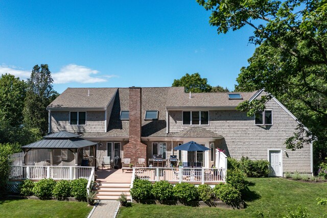11 Polaris Dr, Mashpee, MA 02649 - view of front facade with a gazebo, a front lawn, a deck, and roof with shingles